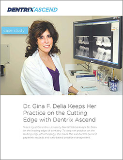 Female dentist in white coat examining dental x-rays in Dentrix Ascend software